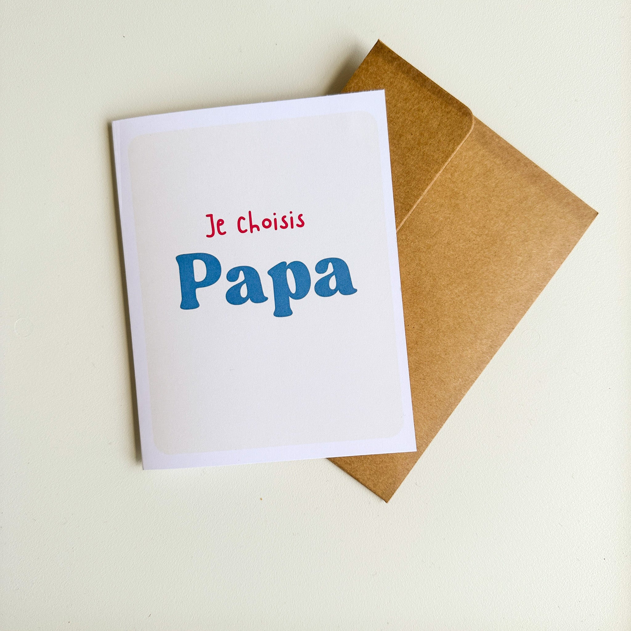 Carte de voeux avec typographie clean et bold affichant « Je choisis papa » en lettres rouge et bleu sur fond blanc